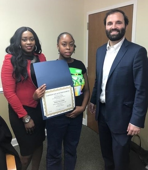 Beaufort housing authority's Poster Winner holding their certificate