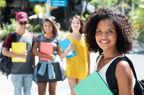 Girl smiling and holding notebook