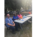Beaufort Staff members participating in national night out with local law enforcement sitting at a table.