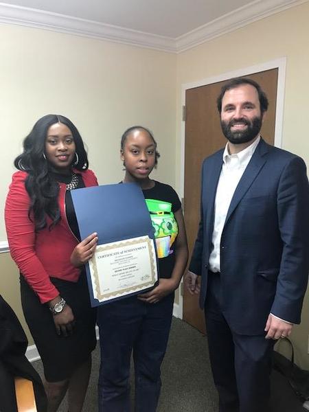 BHA Poster Winner holding her award with Beaufort Staff Members