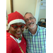 Group selfie of two staff members, one in Holiday outfit