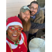 Group selfie of three staff members outside, one is in a Holiday outfit