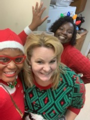 Group selfie of Three staff members in Holiday outfits