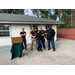 group of five people helping