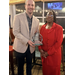  A woman and a man hold an award. 