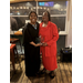  A woman holds an award with another woman. 